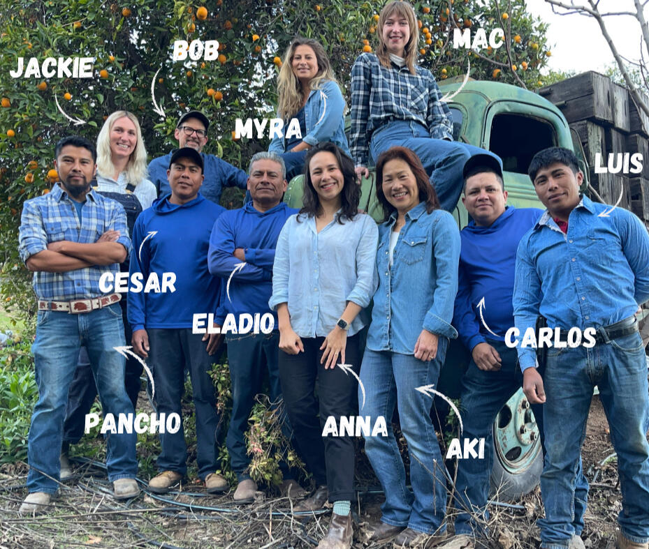 Meet the farmers - a photo of farmers Bob, Anna, Aki, Pancho, Eladio, Jackie, Mac, Carlos, Luis, and Cesar standing in front of a vintage truck.
